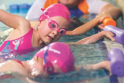 Swim students practicing in the water