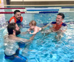 Richard Cahalan and son Jesse teaching a student in the pool