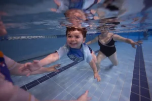 Student smiling underwater