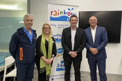 Group photo infront of rainbow club banner