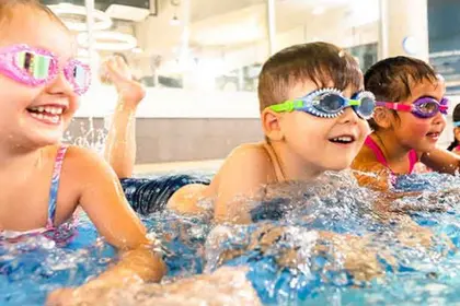 Children smiling and splashing in water