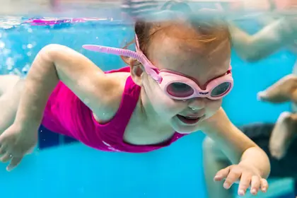 Young girl swimming taken underwater