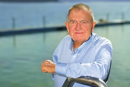 Forbes Carlile standing in front of a pool