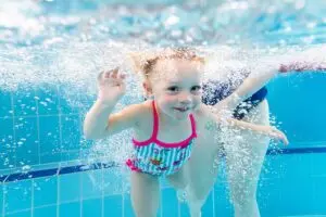 Student smiling underwater