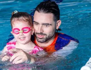 Teacher and student smiling in the water together