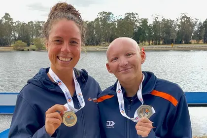 Two Carlile Swimmers holding up their medals
