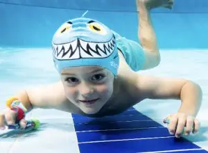 Student smiling underwater