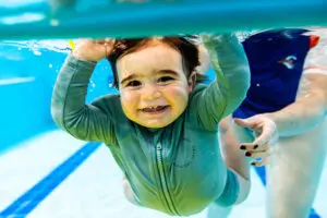 Student smiling underwater