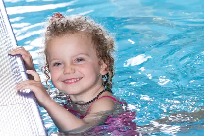 Young girl smiling in the pool