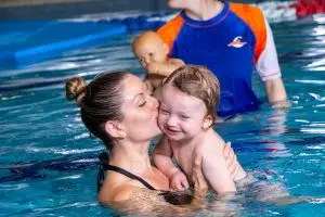 Mum and baby smiling in the pool together