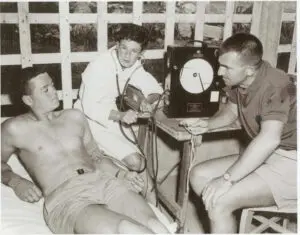 Forbes and Ursula Carlile testing Terry Gathercole in 1958