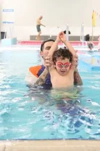 Teacher correcting students form in the water