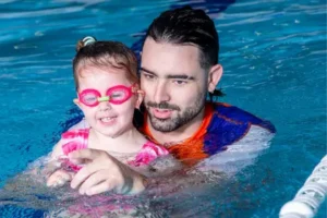 Swim Teacher and young girl in pool