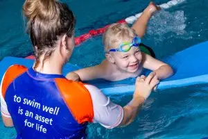 Student smiling while playing with teacher