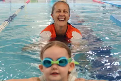 Swim Teacher and young girl smiling in pool