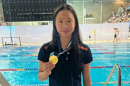 Carlile Swim Team champion with a gold medal